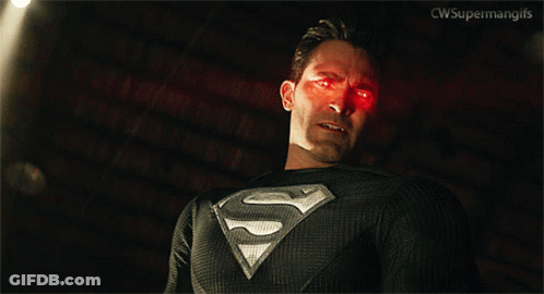 Man In Superman Costume Standing By Pile Of Boxes GIF