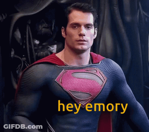 Man In Superman Costume Standing In Front Of Black Curtain GIF