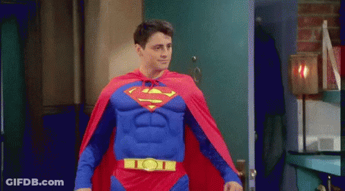 Man In Superman Costume Walking Through Doorway GIF