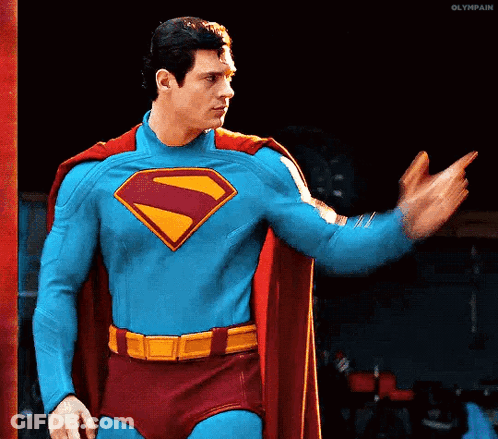 Man In Superman Costume Waving GIF