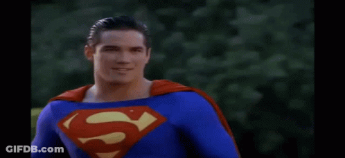 Man In Superman Costume With Red Cape Smiling GIF