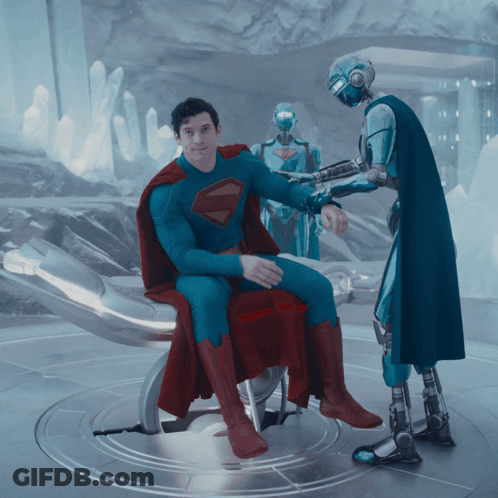 Man In Superman Suit In Chair GIF