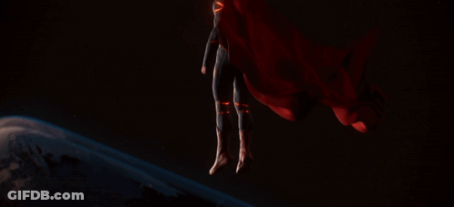 Man In Superman Suit In Front Of Planet GIF