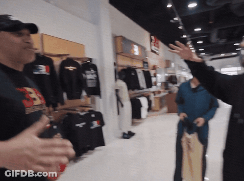 Man In Supreme Shirt Talking To Another Man GIF