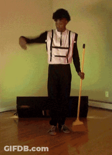 Man In Suspenders Holding Broom And Dancing GIF