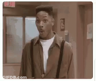 Man In Suspenders Mouth Open In Hallway GIF