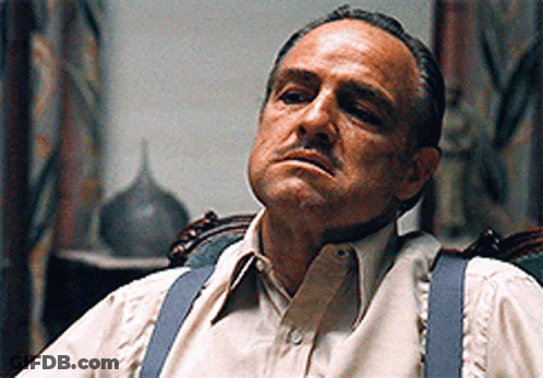 Man In Suspenders Sitting In Chair Eyes Closed GIF