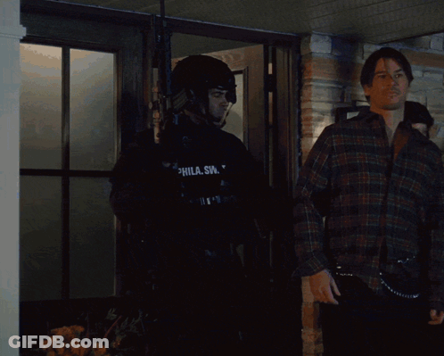 Man In SWAT Uniform In Front Of Building GIF
