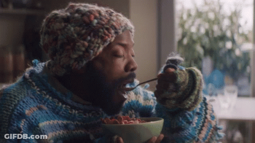 Man In Sweater And Hat Eating Cereal GIF