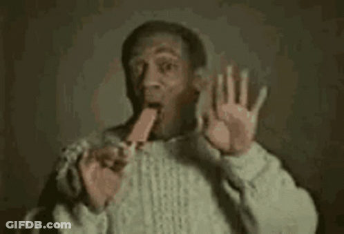 Man In Sweater Eating Popsicle Making Funny Face GIF