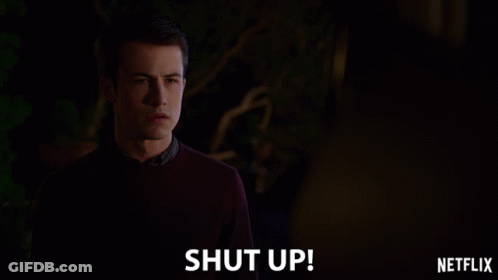 Man In Sweater In Front Of Shut Up Sign GIF