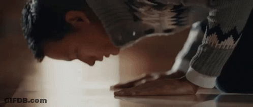 Man In Sweater Kneeling Down GIF