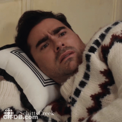 Man In Sweater Lying On Pillow Schitts Creek GIF