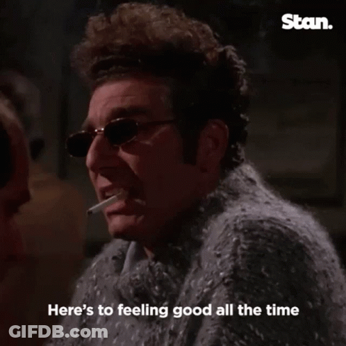 Man In Sweater Smoking Cigarette Saying Cheers GIF