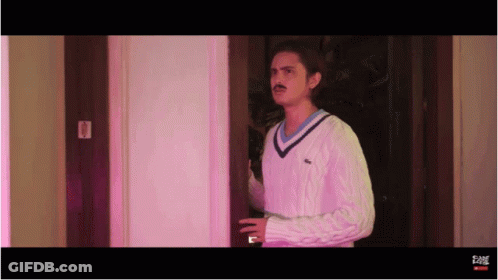 Man In Sweater Standing In Doorway GIF