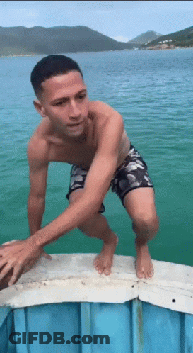 Man In Swim Trunks Standing On Dock GIF