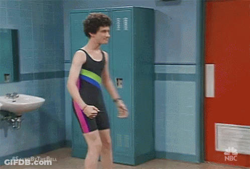 Man In Swimsuit Beside Lockers In Bathroom GIF