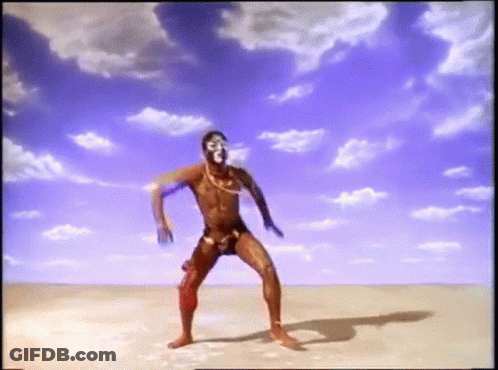 Man In Swimsuit Dancing In Desert GIF
