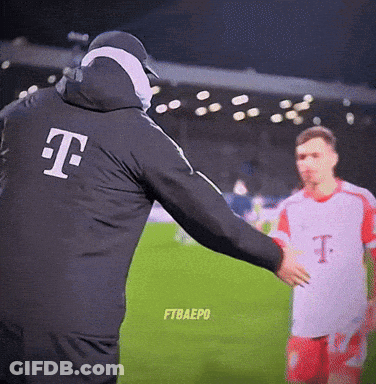 Man In T-Mobile Jacket Talks To Soccer Player GIF