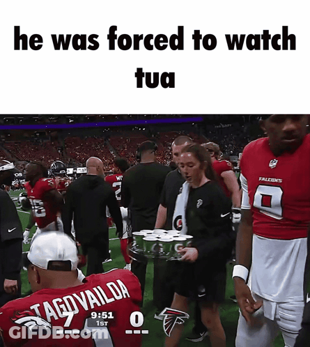 Man In Tagovaildia Jersey Escorted By Woman With Gatorade Tray GIF