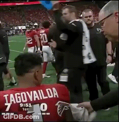 Man In Tagovailoa Jersey Helped By Man In Suit GIF