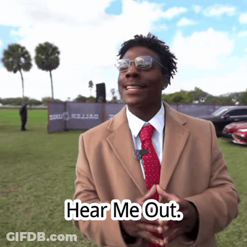 Man In Tan Coat And Red Tie Says Hear Me Out GIF
