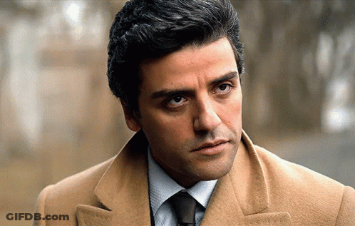 Man In Tan Coat And Tie Looks Serious GIF