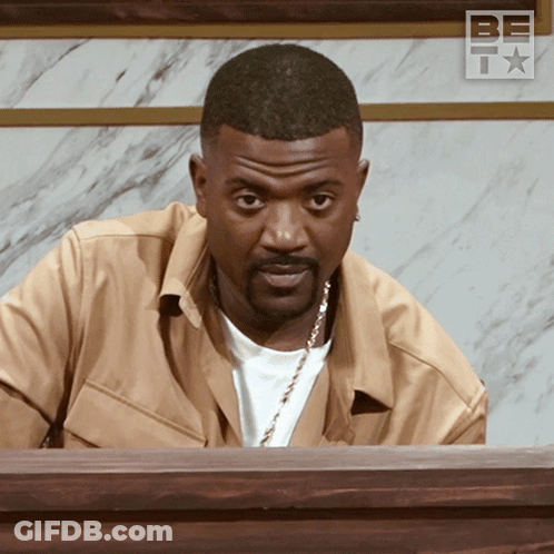Man In Tan Jacket At Table With BF Logo GIF