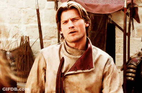 Man In Tan Jacket Red Collar Looking At Camera GIF