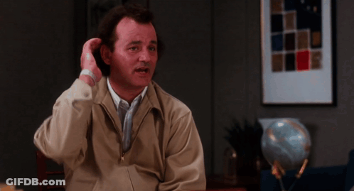 Man In Tan Jacket Sitting At Table GIF