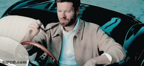 Man In Tan Jacket Sitting In Black Car GIF