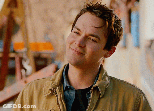 Man In Tan Jacket Smiling Looking To Side GIF