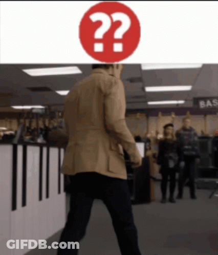 Man In Tan Jacket Walks Past Red Question Mark GIF