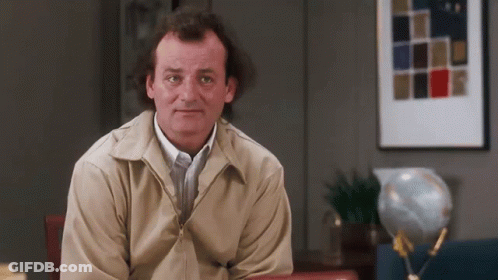 Man In Tan Jacket With Globe GIF