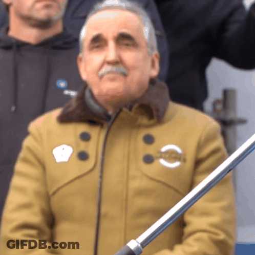 Man In Tan Jacket With NC Sticker GIF
