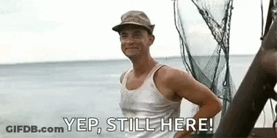 Man In Tank Top And Hat Standing On Boat GIF