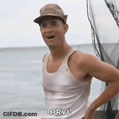 Man In Tank Top And Hat Standing On Boat GIF
