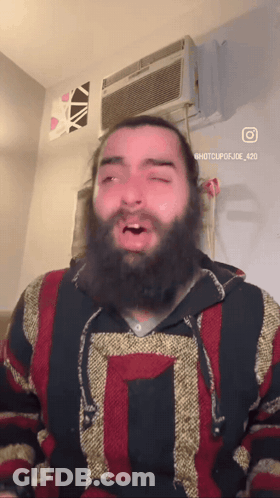 Man In Tank Top And Shorts Crosses Arms GIF