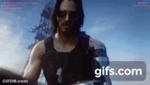 Man In Tank Top And Sunglasses Holding Gun GIF