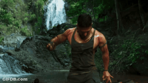 Man In Tank Top In Front Of Waterfall GIF