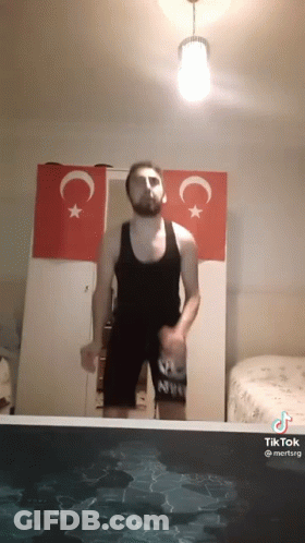 Man In Tank Top Jumping Into Pool GIF
