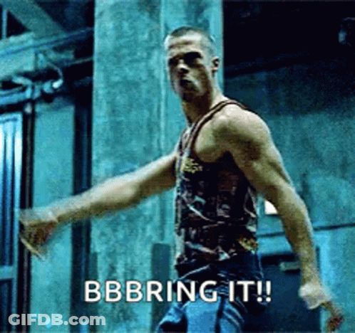 Man In Tank Top Saying Bbbring It In Dark Room GIF