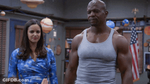 Man In Tank Top Standing Next To Woman GIF