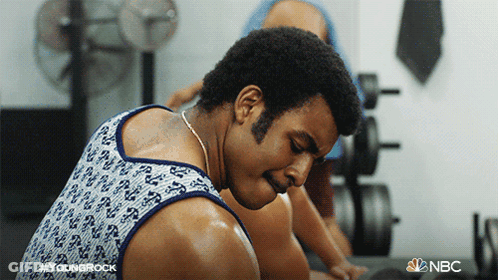 Man In Tank Top Sweating In Gym With NBC Logo GIF