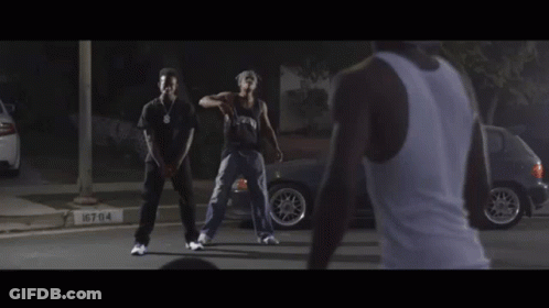Man In Tank Top Watching Two Men Dancing GIF
