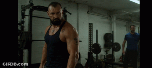 Man In Tank Top With 'A' Tattoo GIF