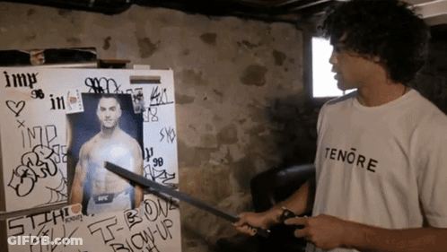 Man In Tenere T-Shirt Holding Sword GIF
