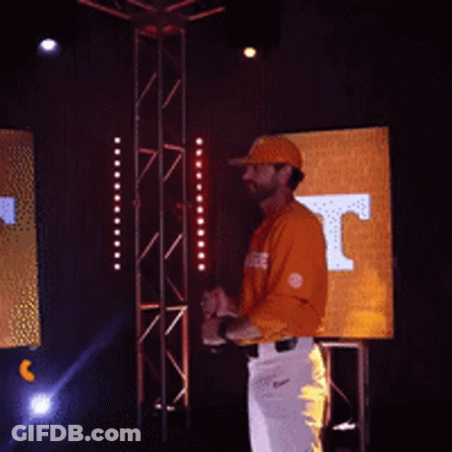 Man In Tennessee Shirt Holding Hat Up GIF