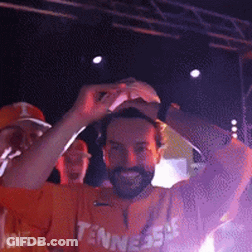 Man In Tennessee Shirt Holding Hat Up GIF