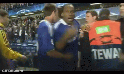 Man In Tewa Vest In Crowd GIF